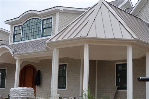 white house with a champange metal roof|white metal roof exterior homes.